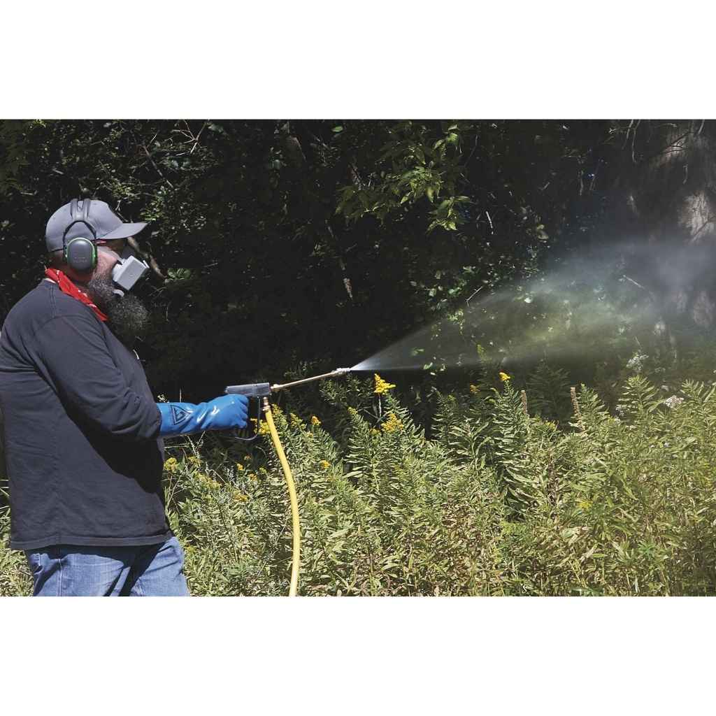 Person using a Northstar skid sprayer 55 gallon capacity 180cc to clean plants outdoors
