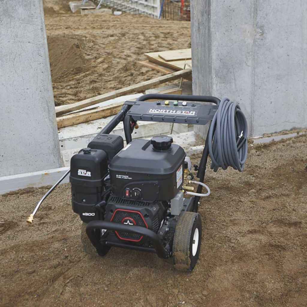 northstar 3600 psi Pressure washer on a construction site with concrete walls and wooden planks in the background.