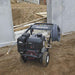 northstar 3600 psi Pressure washer on a construction site with concrete walls and wooden planks in the background.