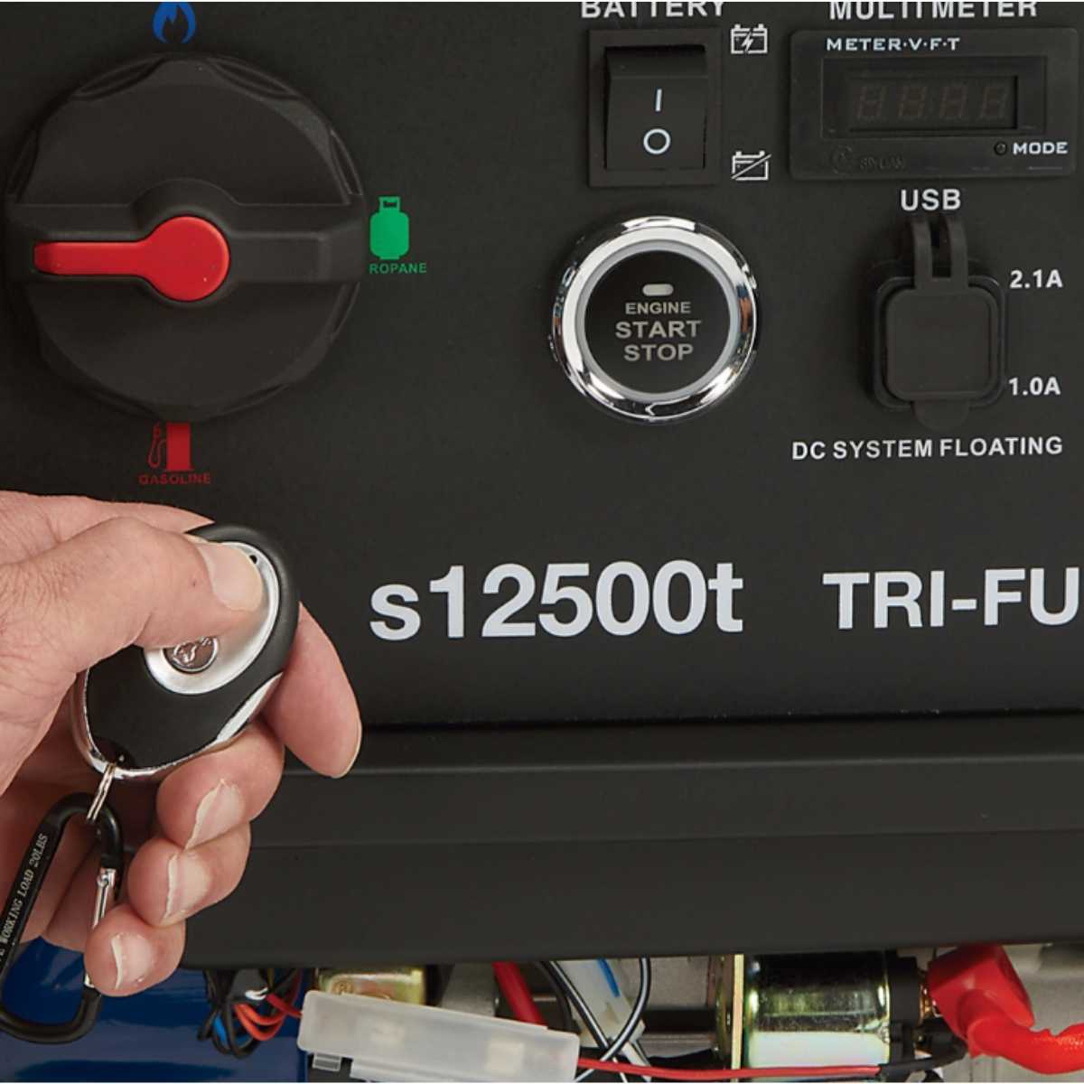 Person holding a key fob to start a powerhorse 12500 watt generator labeled s12500t.