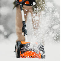 Person using a SuperHandy orange and black snow shovel to clear snow