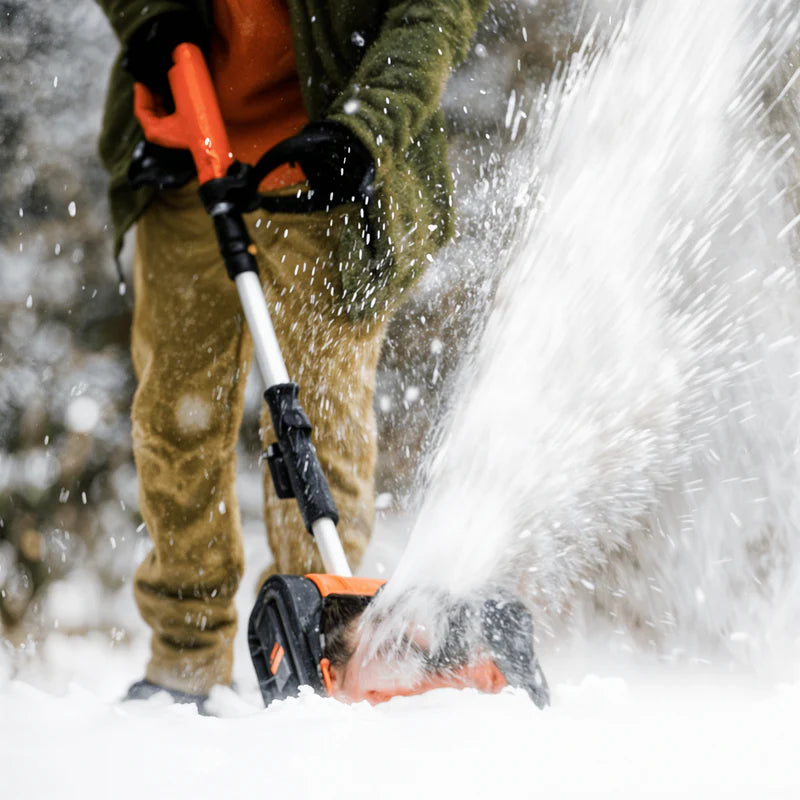 Person using a SuperHandy snow blower to clear snow in winter conditions