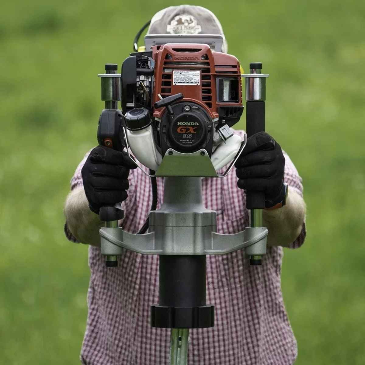 Person holding a Titan post driver pgd3200 against a green background