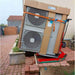 Two air conditioning units stacked on a Zonzini Plasmoid Stabilized Stair climber outdoors with cardboard boxes.
