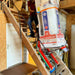 Person using a Zonzini Plasmoid Stabilized to lift a piece of equipment up a staircase in a home renovation setting 