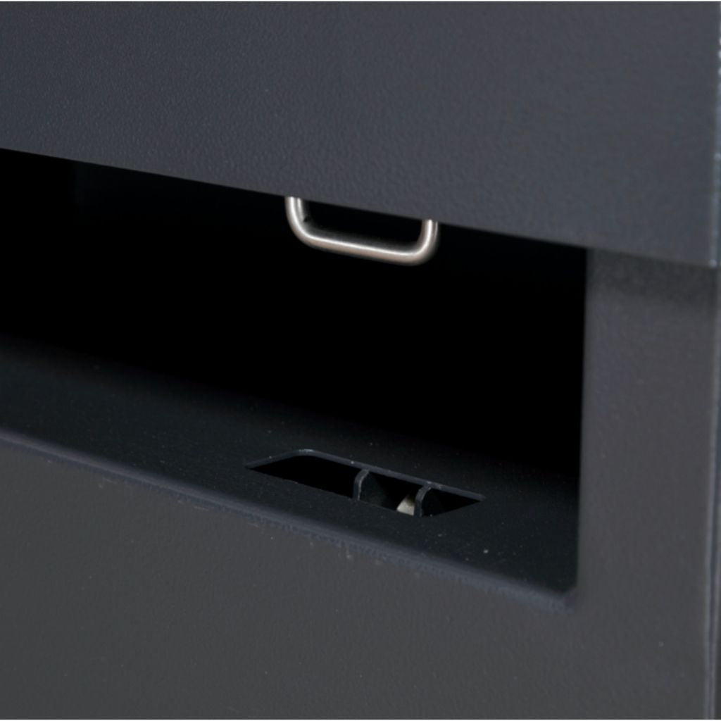 Dark gray drawer to an armorgard siteboss piano box with a handle on a matching cabinet.