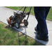 Person using a Bravepro 10 in lawn edger on a sidewalk