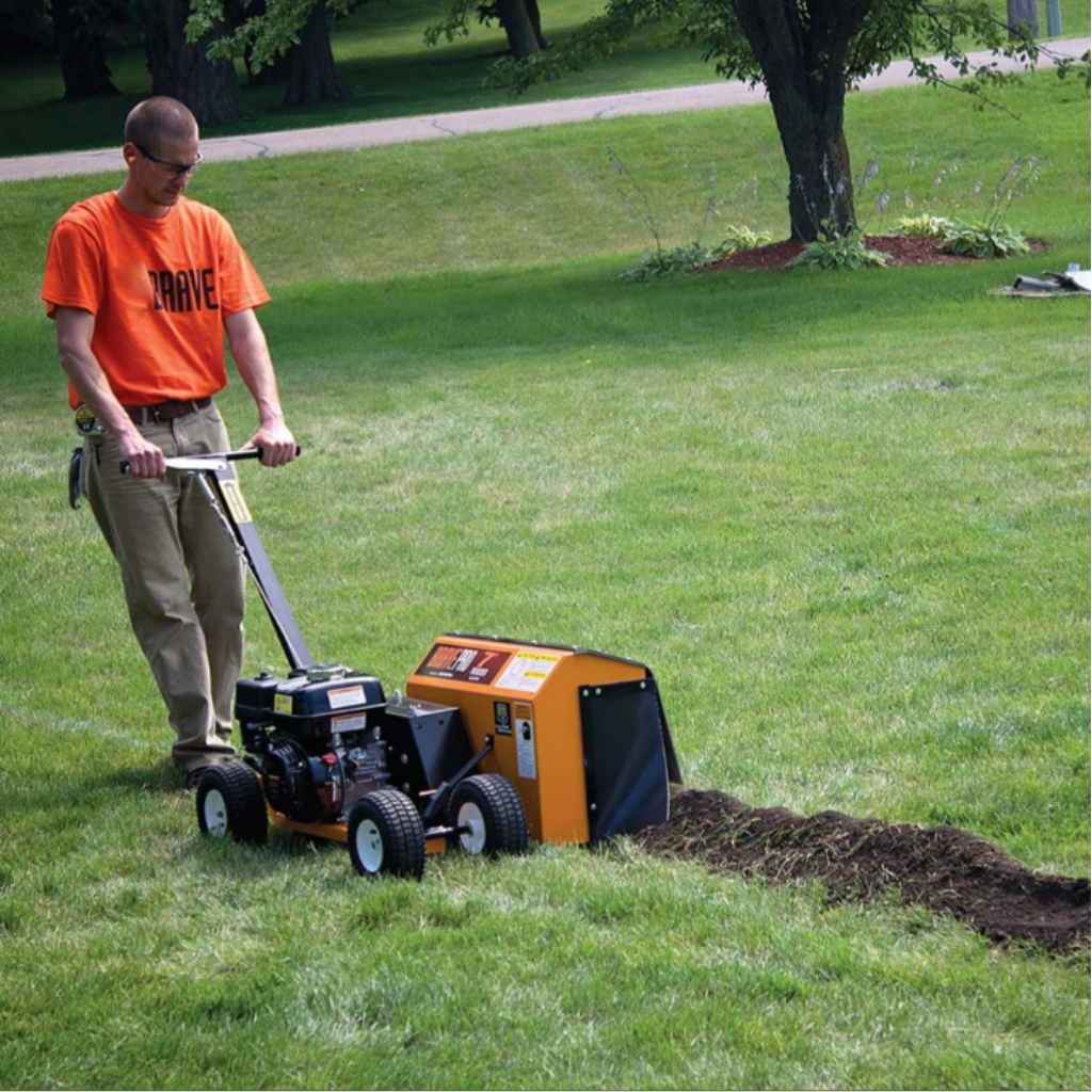 Person using a bravepro 7 mini trencher on a grassy area