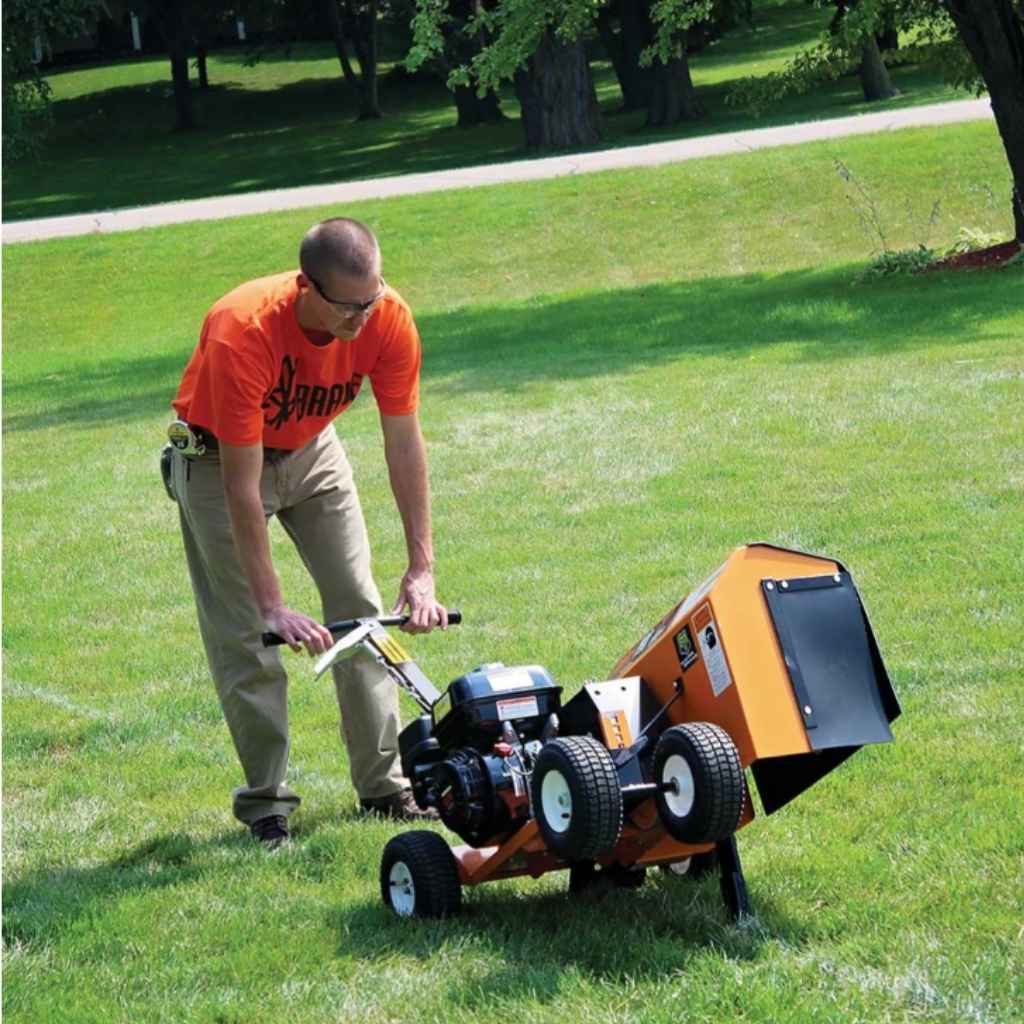 Person using a bravepro 7 inch trencher on a grassy area with trees in the background