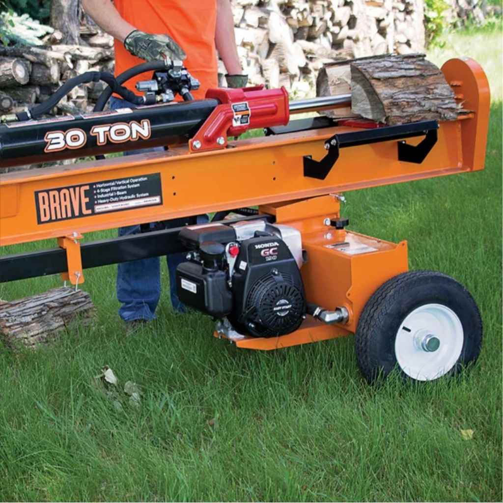 Orange brave pro 30 ton towable log splitter with 'Brave' branding on a grassy background