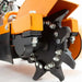 Close-up of an orange and black brave pro stump grinder on a white background