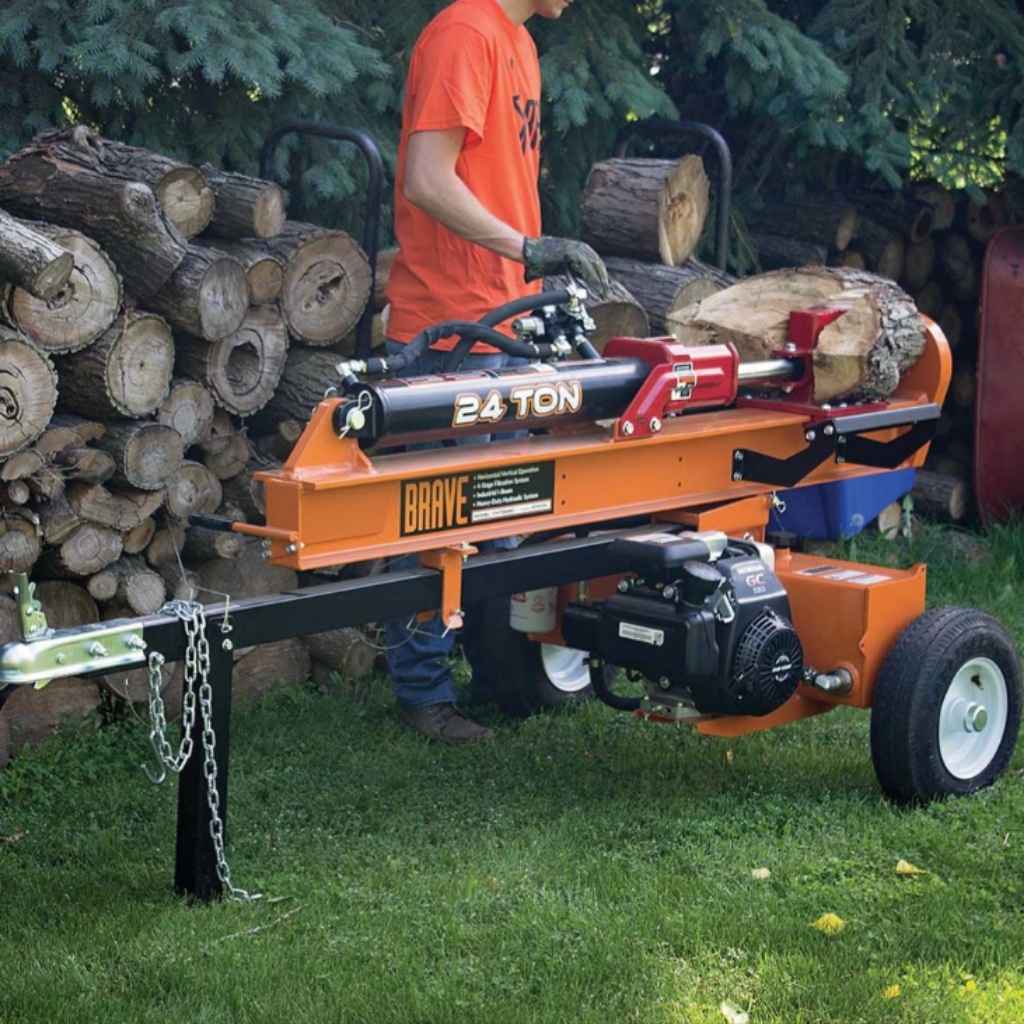 Person using a brave 24-ton log splitter with logs around in an outdoor setting