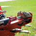 Person using a red and orange bravepro 37 ton log splitter on a grassy area