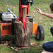Person using a brave pro 37 ton log splitter with a visible 'Braver' brand on a grassy background.