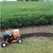 Bravepro bed edger in a field with rows of green plants.
