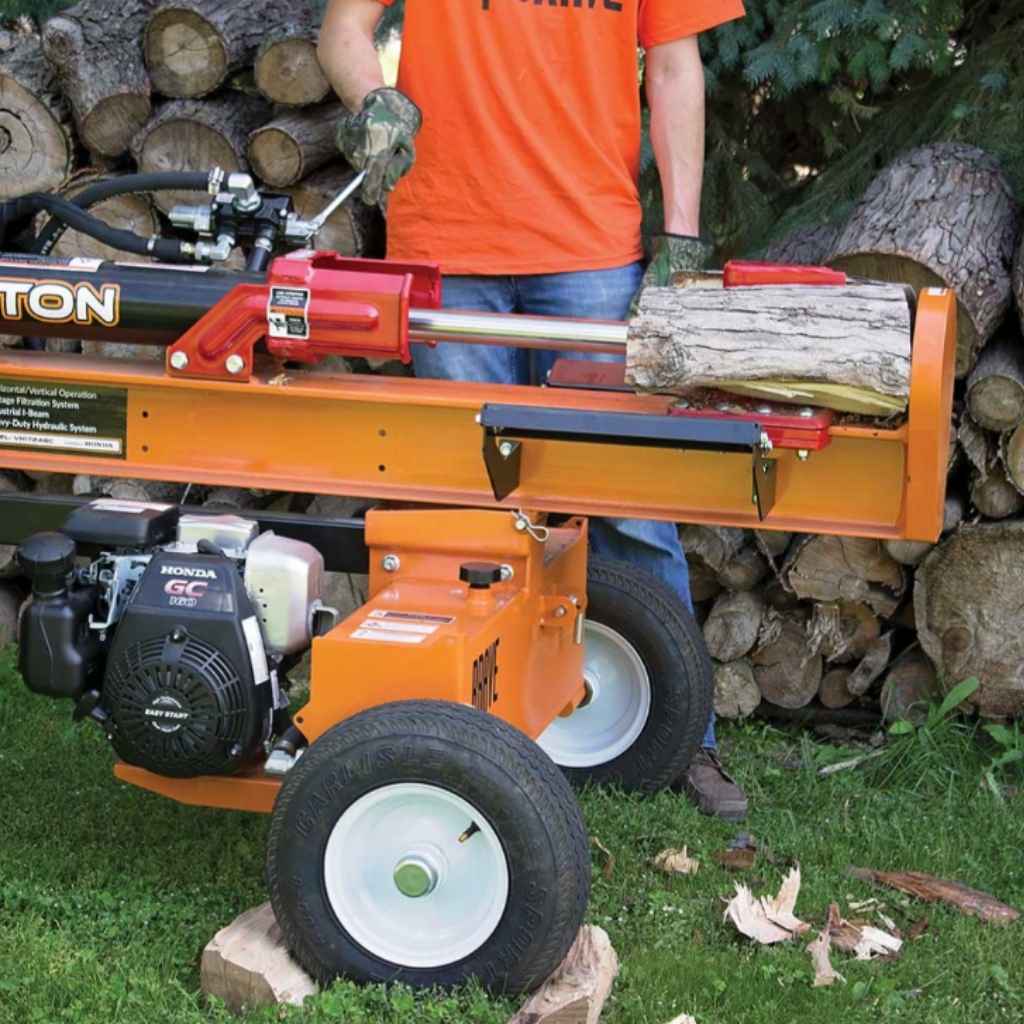 Person operating a brave pro towable 24 ton log splitter with logs around