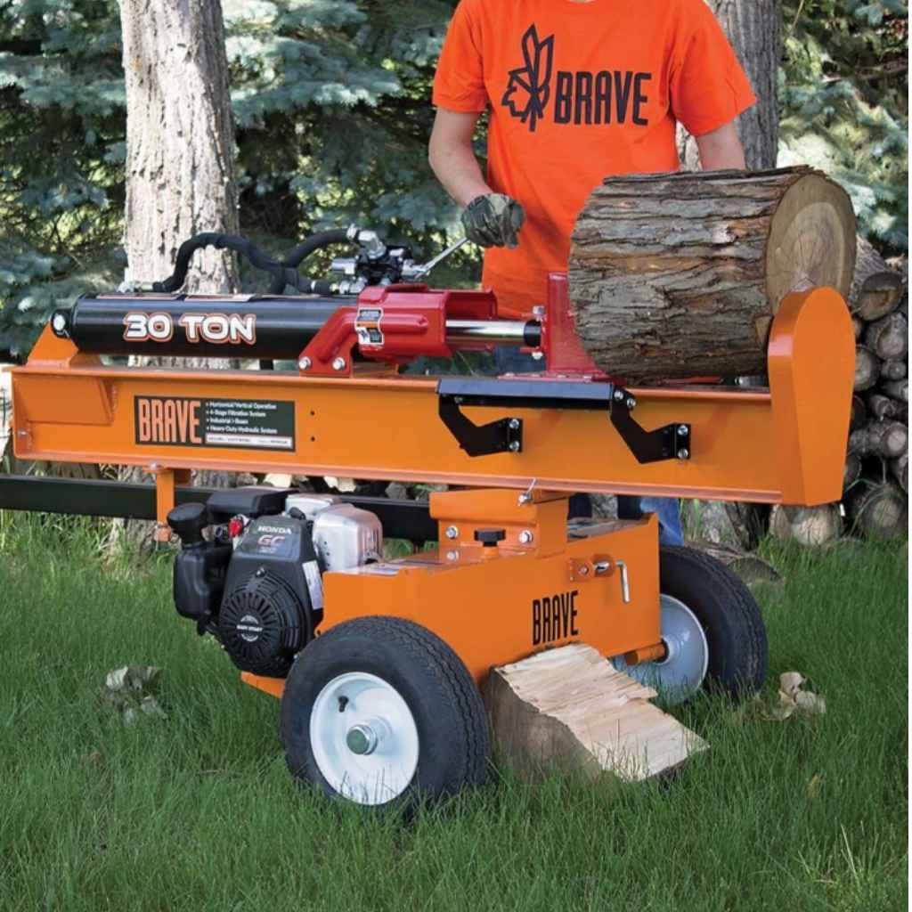 Orange bravepro 30 ton log splitter with a person in an orange shirt labeled 'Brave' in a forest setting.