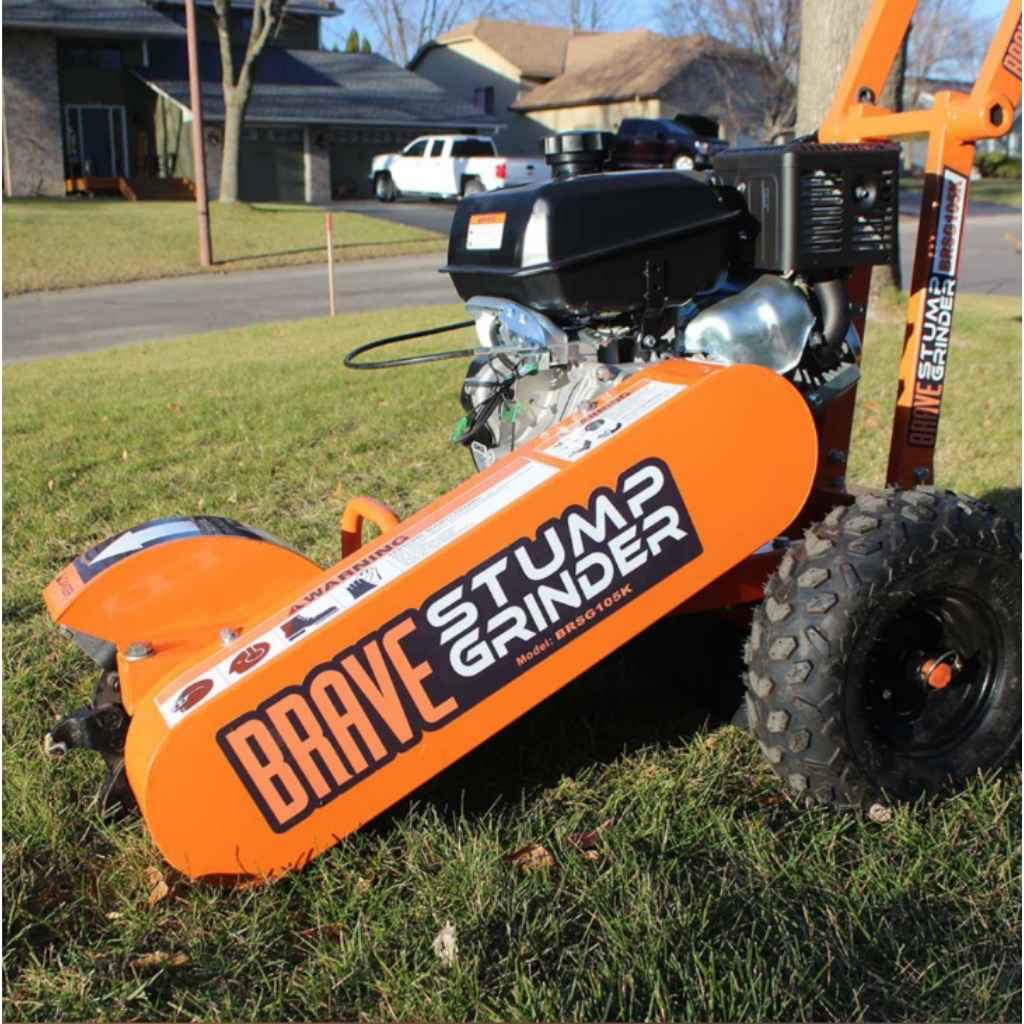 Orange brave 4 hp stump grinder with 'Brave Stump Grinder' branding on a grassy area.