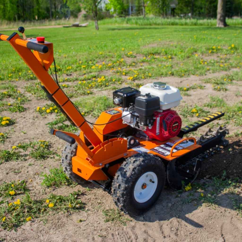 Orange brave 18 trencher on a grassy field with trees in the background