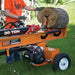 Person operating a brave 30-ton log splitter with a log on a grassy area