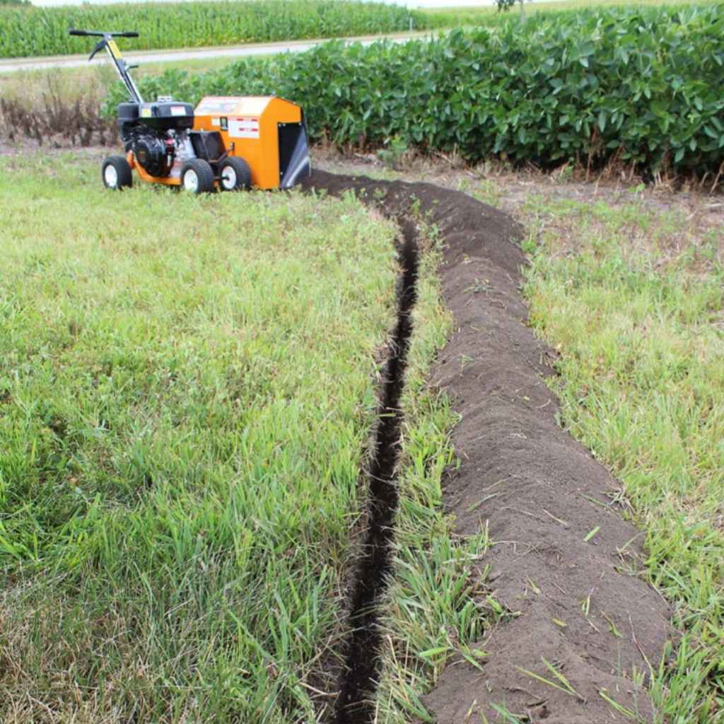 Brave pro bed edger bed sculptor creating a furrow in a field with rows of crops in the background.