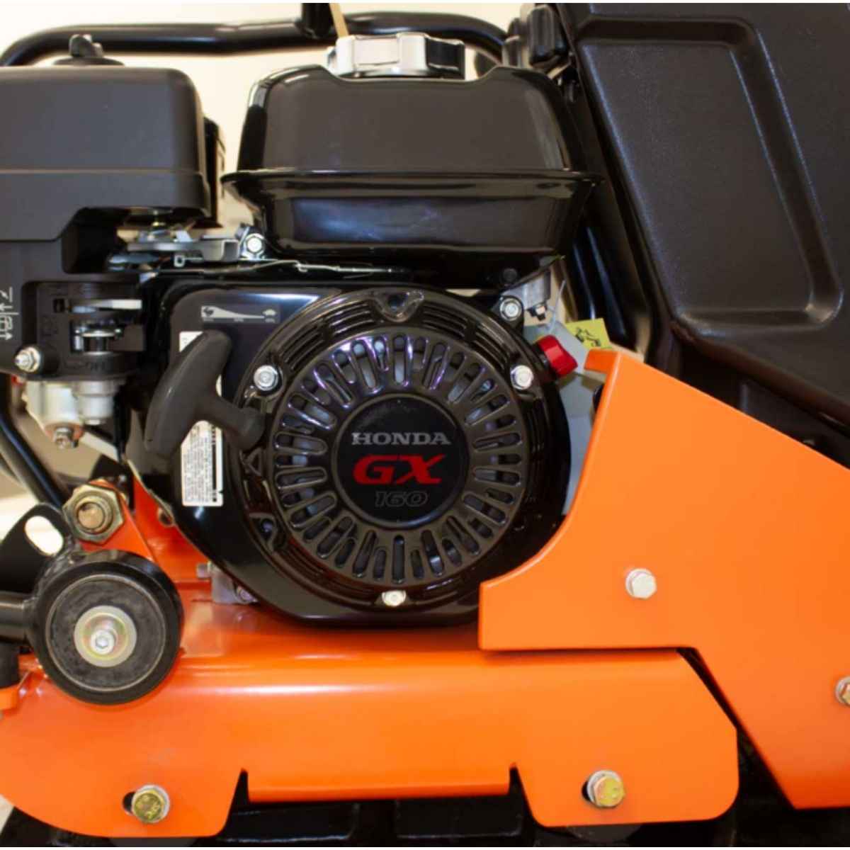 Close-up of a brave plate compactor 20 in. BRPFP145H with a Honda GX engine on an orange machine.