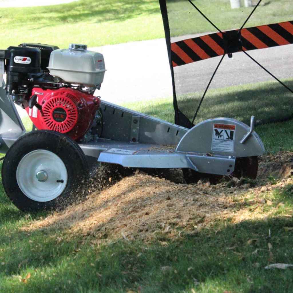 dosko 13 hp stump grinder walk behind being used on grass with a red engine cover.