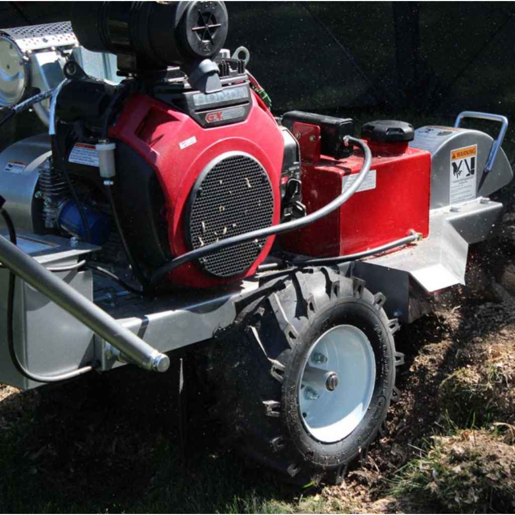 Red and gray dosko self propelled stump grinder 20 hp in use on a grassy area