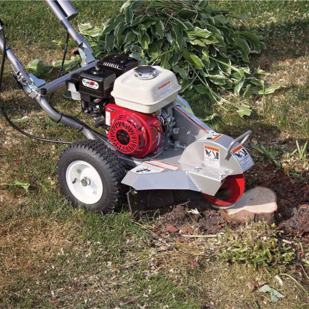 Dosko mini stump grinder in use on a tree stump with grass in the background