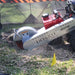 Dosko self propelled 20 hp stump grinder in use on a grassy area with a yellow flag.