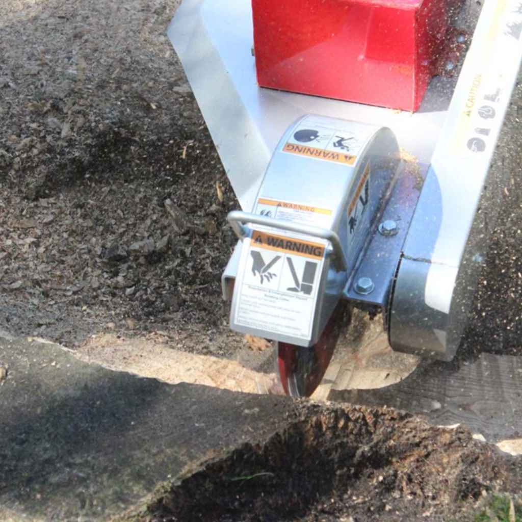 dosko 20 hp self propelled stump grinderStump grinder in action, cutting a stump with visible brand.