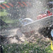 Close-up of a dosko self propelled stump grinder in action with snow being blown