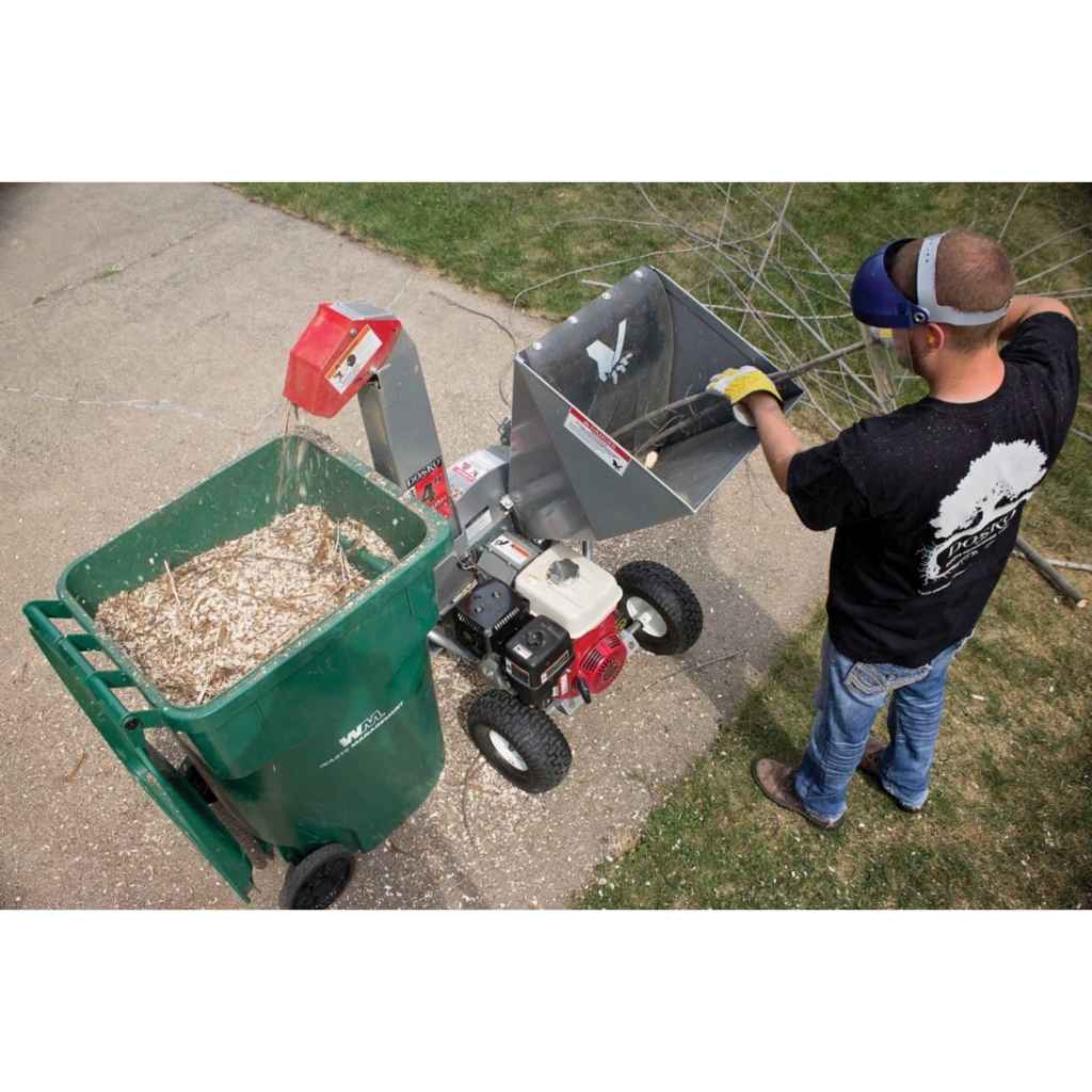 Person operating a dosko brush chipper 4 inch on a driveway