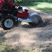dosko 20 hp self propelled Stump grinder in action on a stump in a grassy area