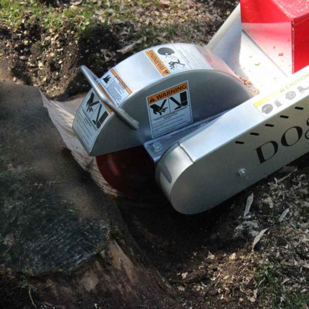 dosko 20 hp self propelled stump grinder in use on a tree stump with visible brand name.