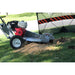 dosko walk behind stump grinder 13 hp being used on grass with a red and black striped barrier in the background