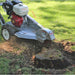dosko walk behind Stump grinder 13 hp removing a stump in a grassy area