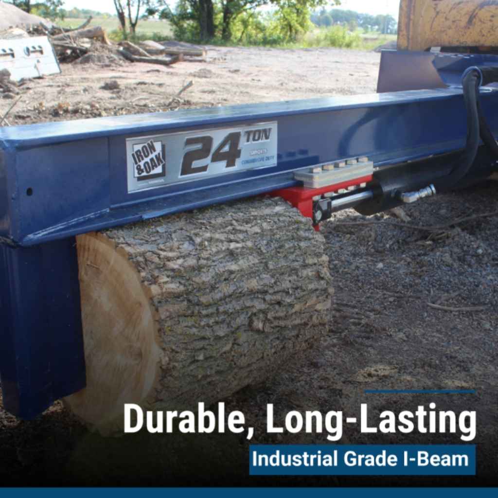 an iron and oak 24 ton skid steer mount log splitter holding a log with trees in the background during the daytime