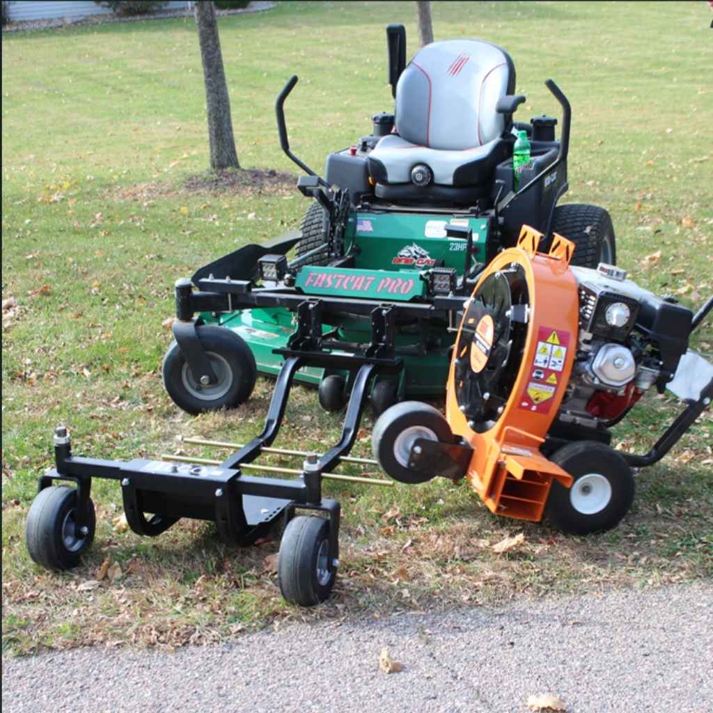 Mower with jrco blower buggy mower attachment and Leaf Blower on a grassy area
