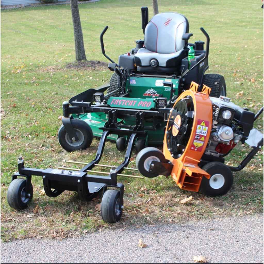 Mower with a jrco blower buggy 601 mower attachment and a Leaf Blower on a grassy area