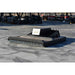 A closed front brush cutter by loflin with a white nameplate reading 'LOFLIN', photographed outdoors on a concrete surface with an industrial yard in the background.