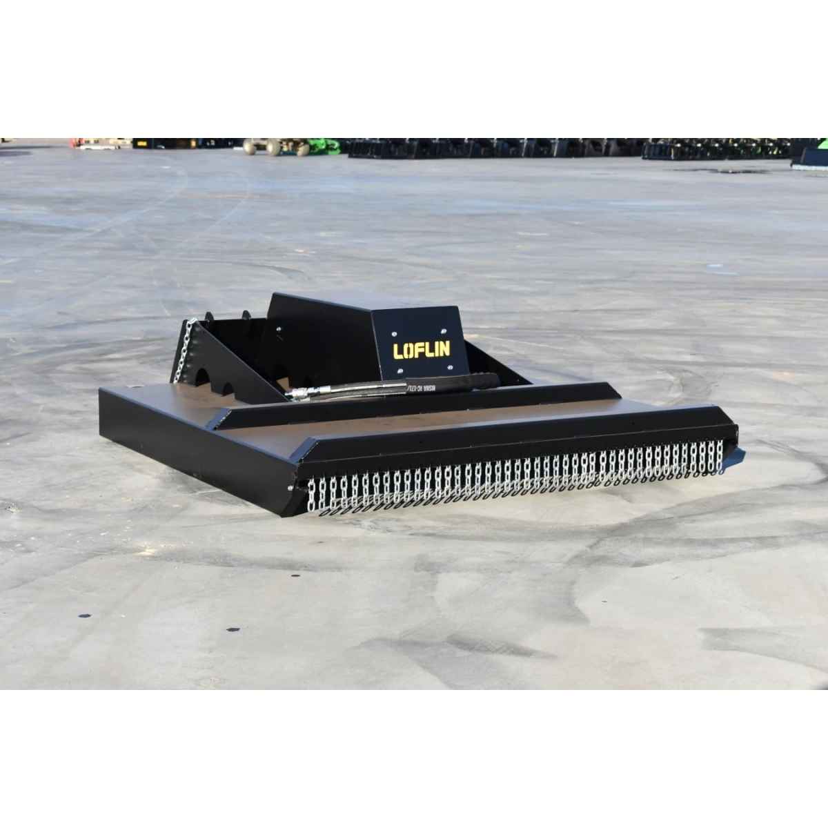 A black Loflin closed front brush cutter attachment with a digital display screen, photographed on a concrete surface.