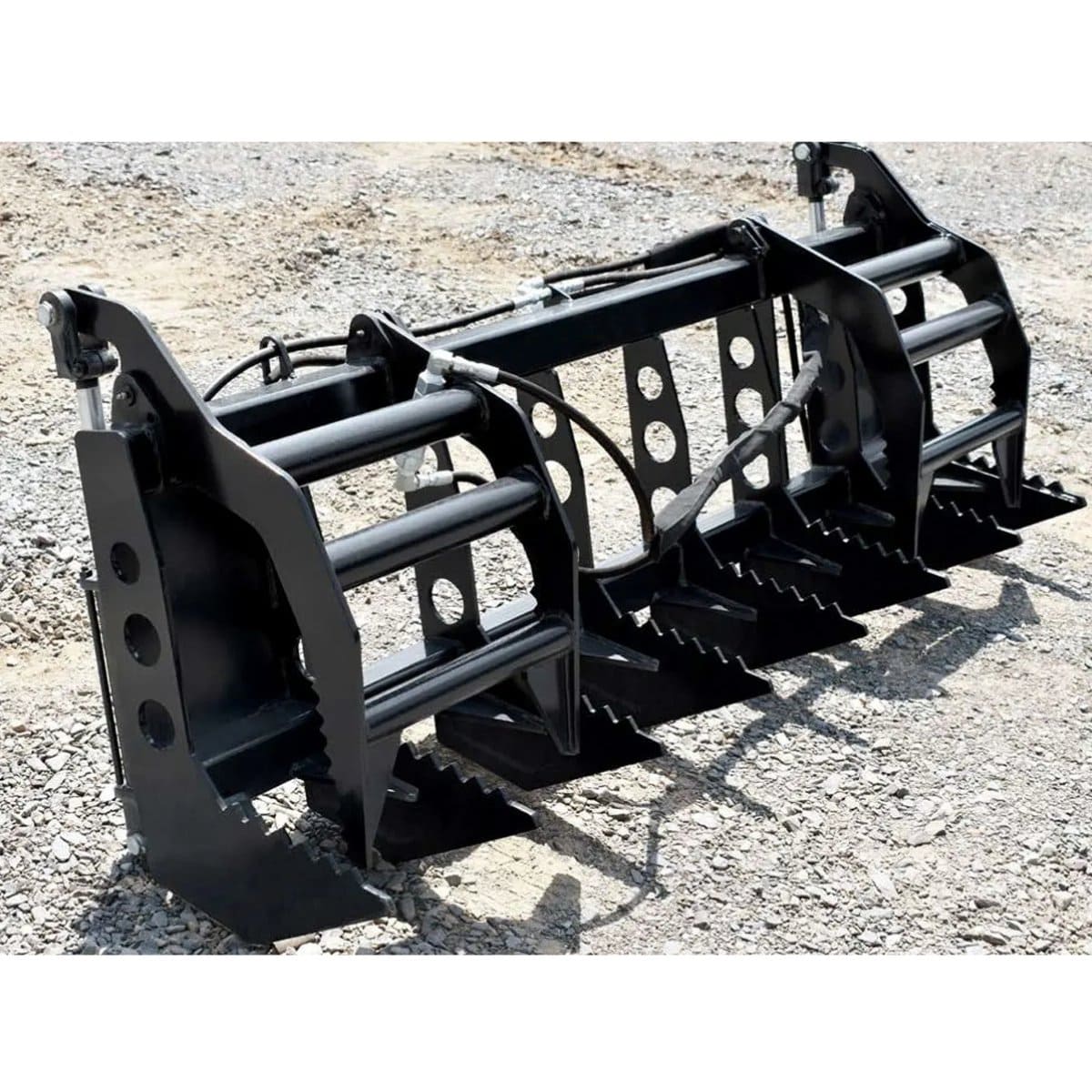 Black loflin compact tractor vertical root grapple attachment on a gravel surface