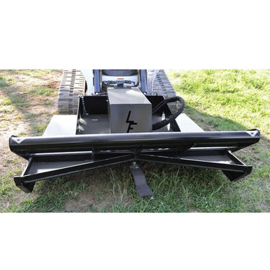Black loflin open front brush cutter for skid steer on a small tracked vehicle in a grassy area