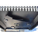 Close-up of the underside of a black loflin closed front brush cutter, showing mounting brackets, a circular light fixture, and rows of white plastic or metal links along the top and bottom edges.