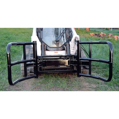 Skid loader with a black loflin bale squeezer for sale on a grassy field