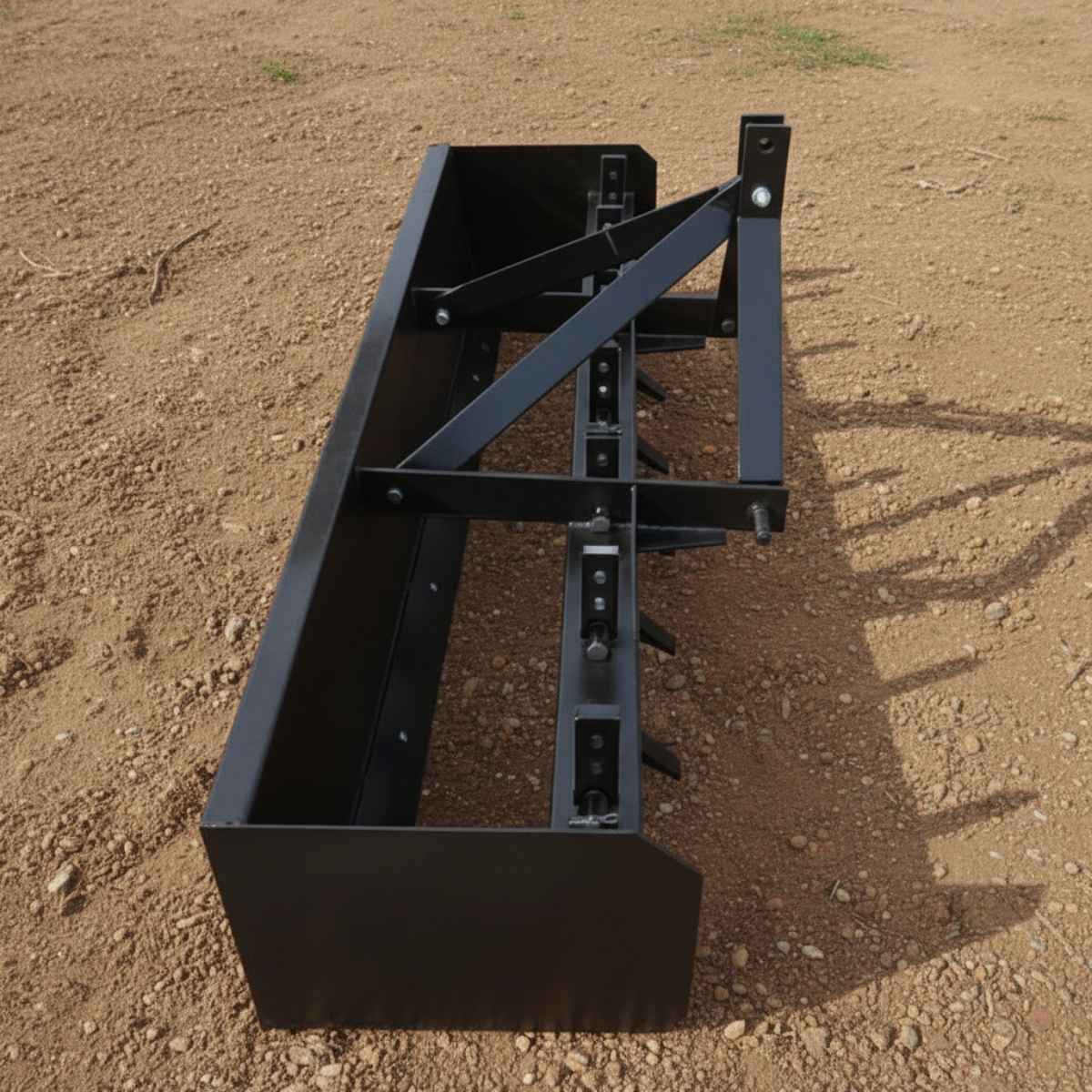 Black loflin box grader on a dirt field