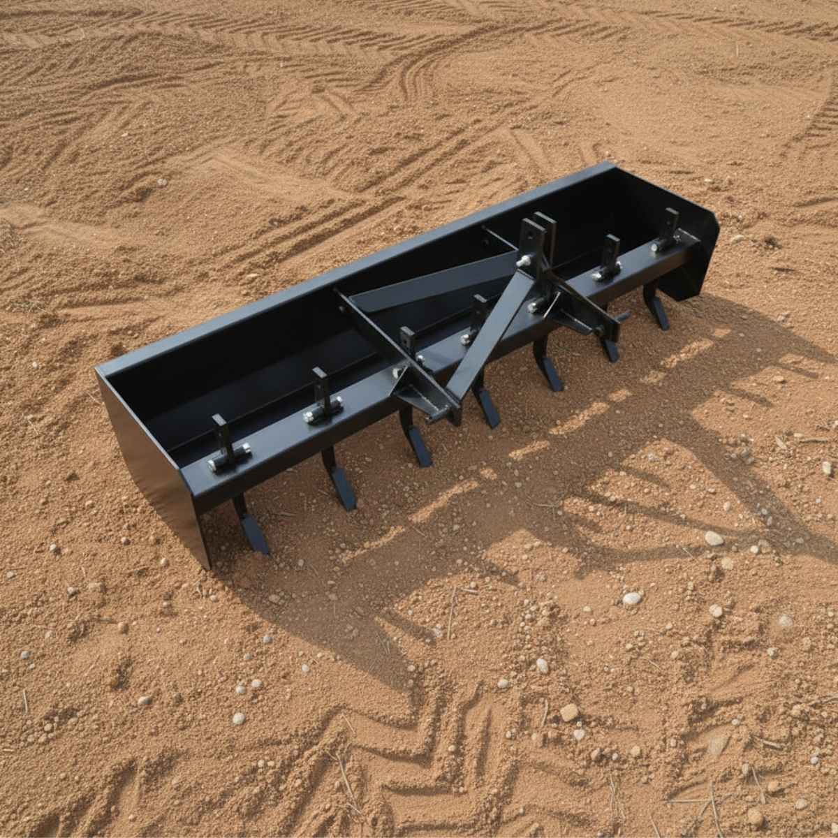 Black loflin fabrication box blade ripper on a brown dirt field