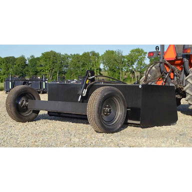 Black loflin tractor land leveler on a vehicle with trees in the background