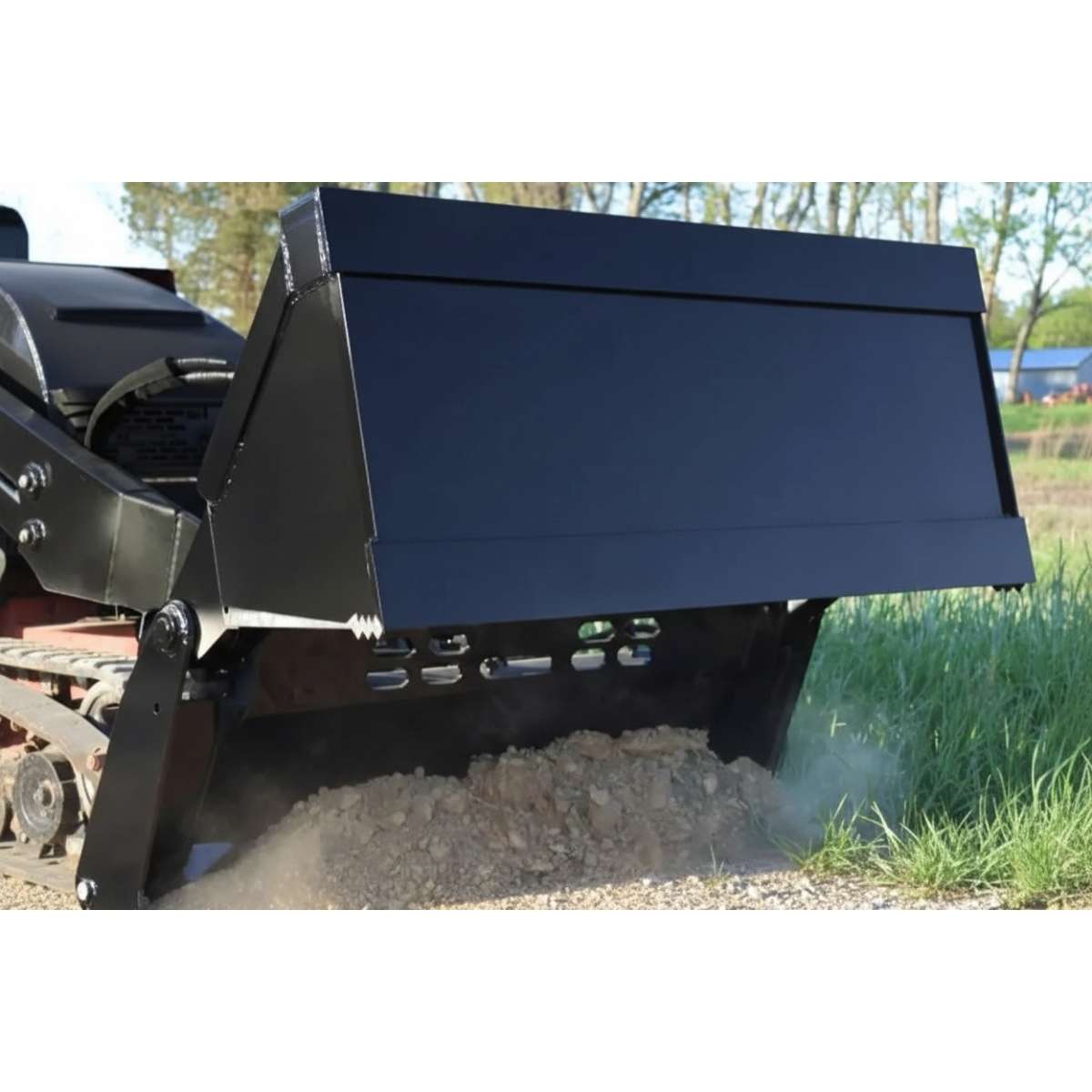Black loflin mini skid steer 4 in 1 bucket on a vehicle clearing snow from a driveway.